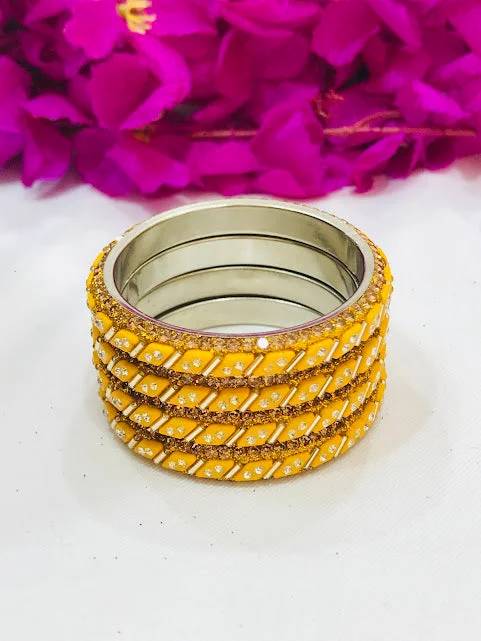 Bracelets with etched floral bands for detail -Dazzling Yellow Colored Metal Bangles For Girls