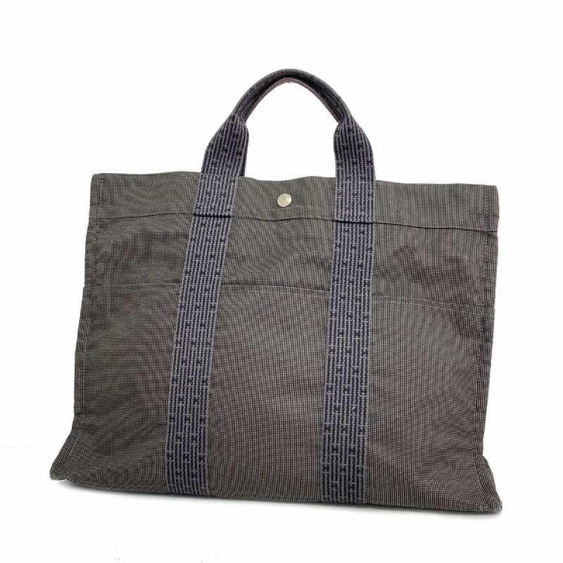 Handle bags with side pockets for organization -Hermes  Canvas Tote Bag (Pre-Owned)